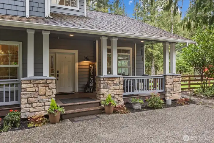 The covered front porch provides a comfortable outdoor space to enjoy the setting year-round.