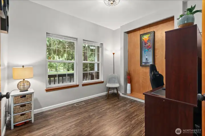 A dedicated office offers flexibility for work, hobbies, or creative space, with views out to the surrounding greenery.