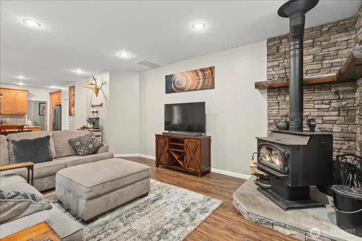 A cozy wood-burning stove framed in stone creates a natural focal point, adding warmth and character to the living space.