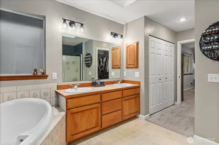 Spacious 5-piece primary ensuite featuring dual vanities, a walk-in shower, and thoughtful layout for everyday comfort.