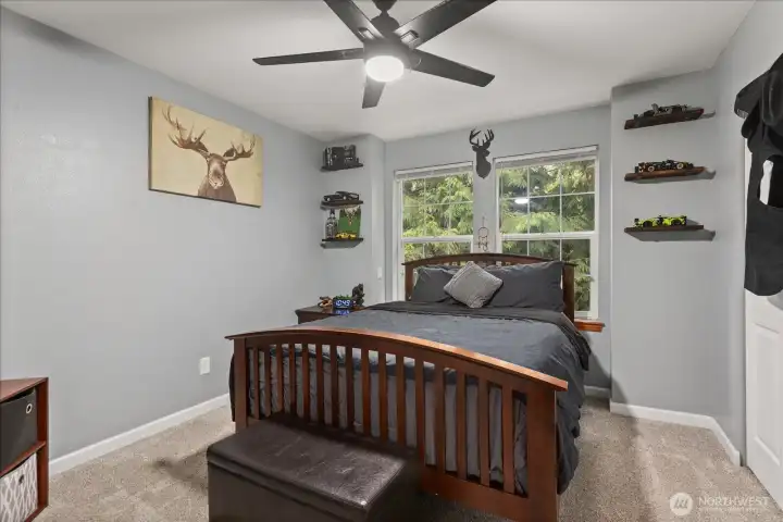 Comfortable bedroom with large windows and a functional layout.