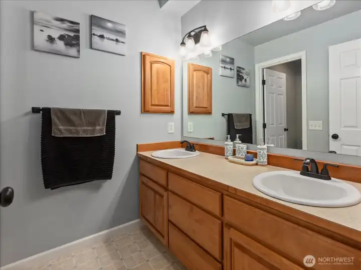 Full bathroom with dual sinks and plenty of counter space.