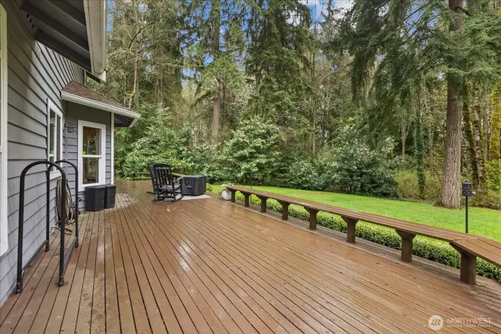 Expansive deck overlooking the private, tree-lined setting—designed for gathering, relaxing, and enjoying the outdoors.