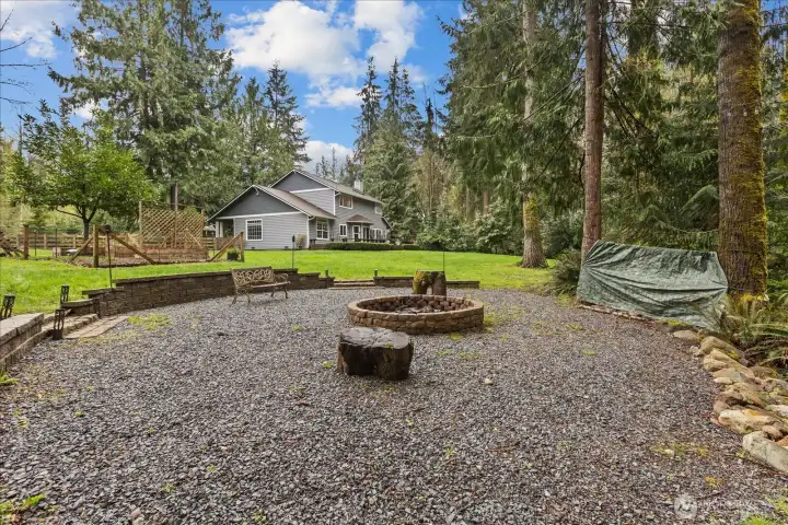 Gather around the firepit in this inviting outdoor space—perfect for evenings under the stars.