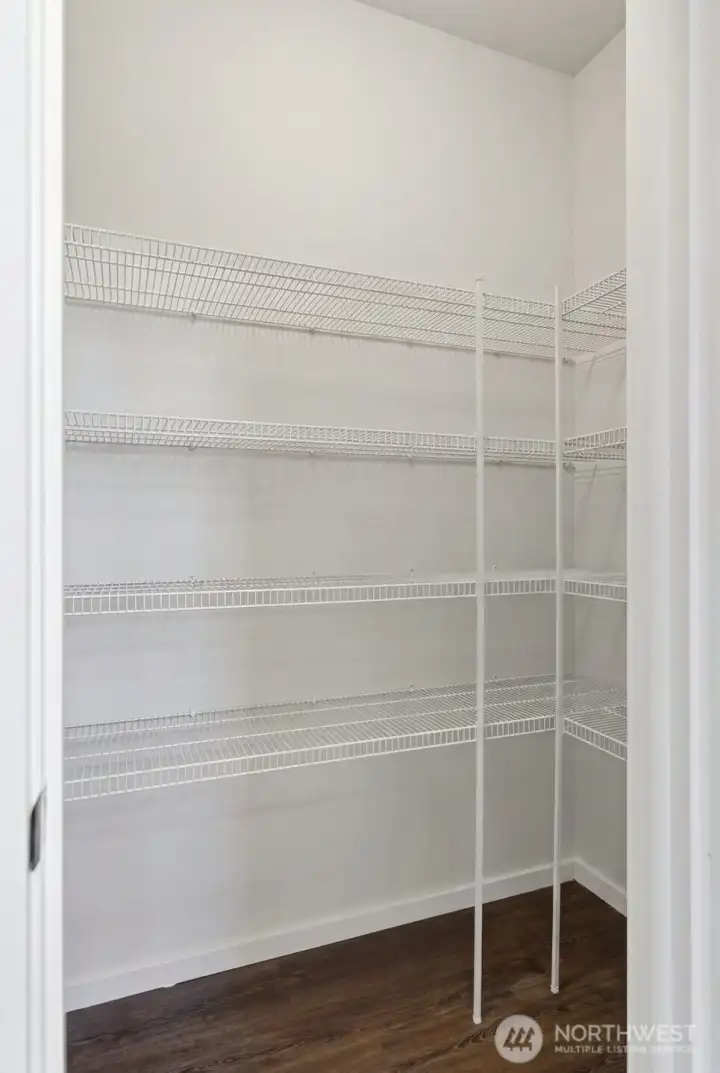 Walk in pantry with wrap around shelving