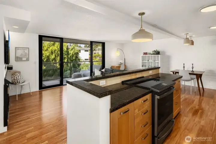 Granite surfaces complement the warm cabinetry.