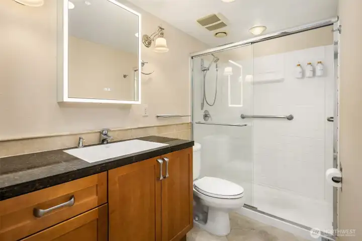 Right around the corner is the stylish bath with granite-topped vanity & XL shower.