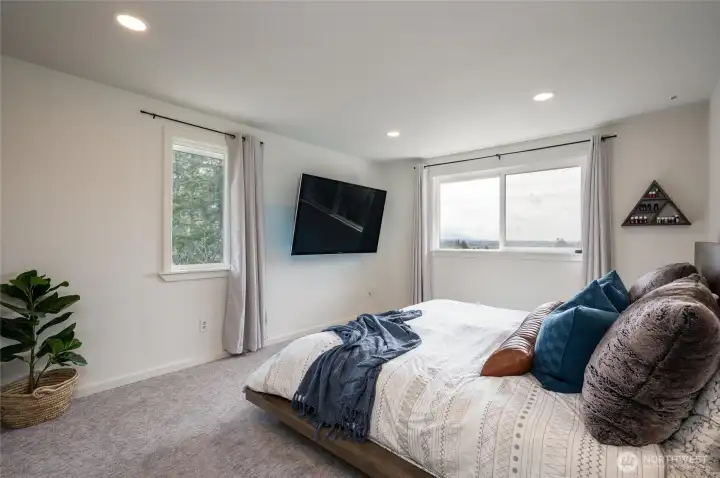 Enjoy the abundance of natural light that pours into this luxurious primary suite. Enjoy the abundance of natural light that pours into this luxurious primary suite.