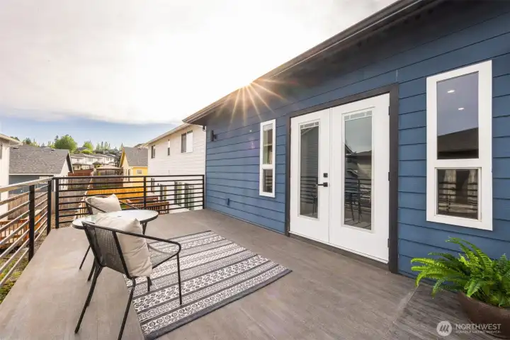 French doors in primary bedroom take you to your own balcony
