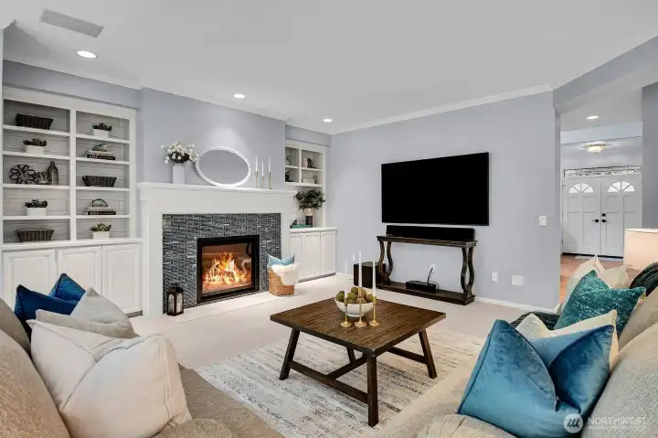 The open, family/great room has a gas fireplace, built-ins and so much versatility in furniture arrangements.