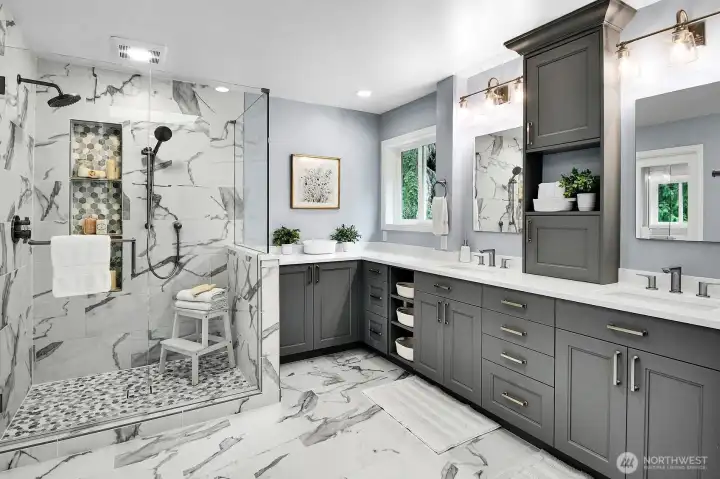 Stunning primary bath with marble, double headed shower and so much storage!