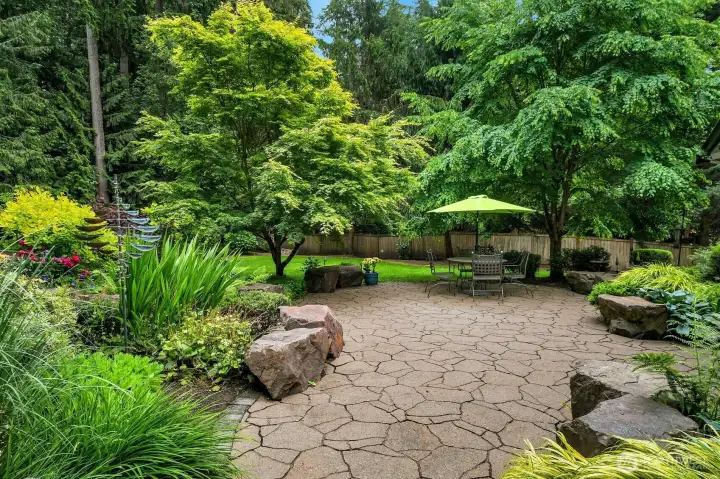 An amazing, truly park-like yard with entertaining spaces, and plenty of room for play and gardening.
