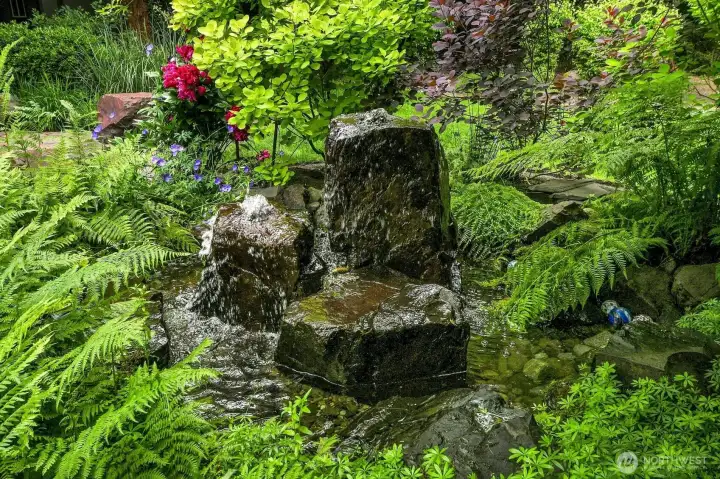 The soothing water feature and pond sets the stage  for relaxation in your own private resort.