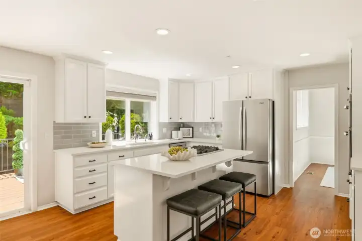 The updated chef's kitchen flows seamlessly into the inviting family room. The updated chef's kitchen flows seamlessly into the inviting family room.