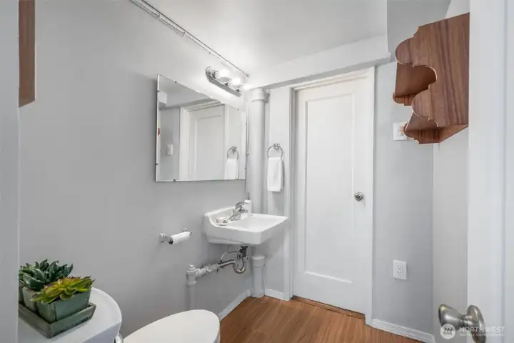 1/2 bathroom on lower level between laundry & garage