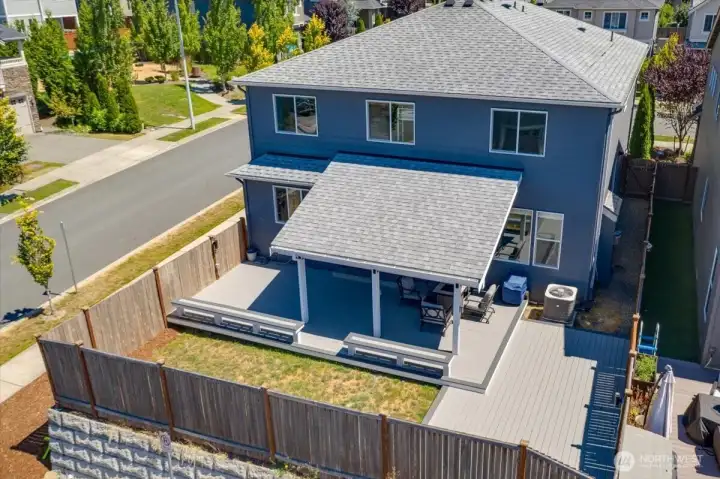 Drone shot from the back, showing off the wonderful outdoor entertainment area and partially covered deck!  Enjoy All the seasons!