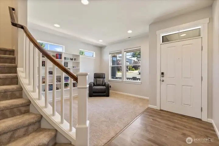 A little curve in this staircase greets you and your guests with syle!  Fun living room with shelving for books or what have you.