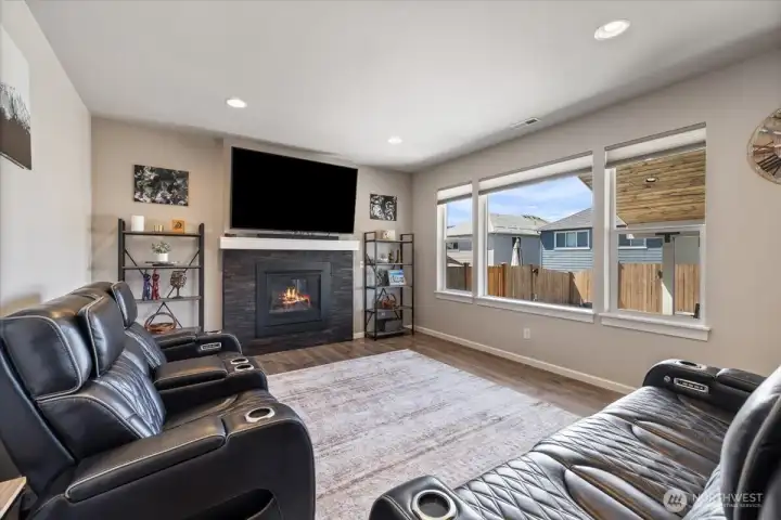 Warm and inviting Family room with Stained wood surrounding the gas fireplace! Your big, comfortable furniture will fit!