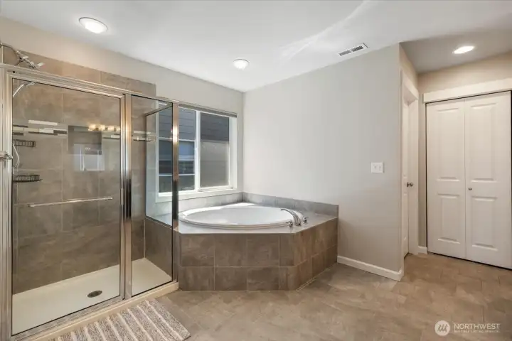 Corner soaking tub with full shower in the Primary bathroom!