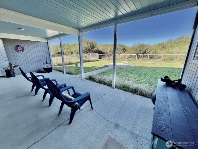 Covered patio with backyard and beach bluff views.