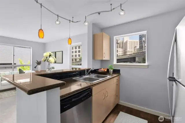 Kitchen with window, granite countertops & stainless steel appliances