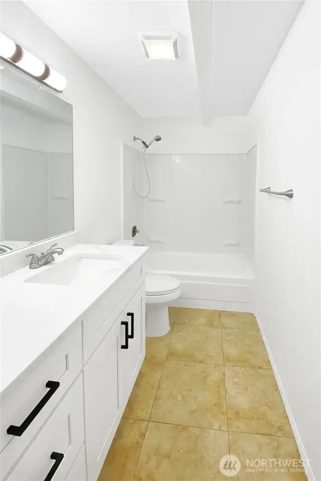 Full bathroom with updated vanity, shower, and fixtures.