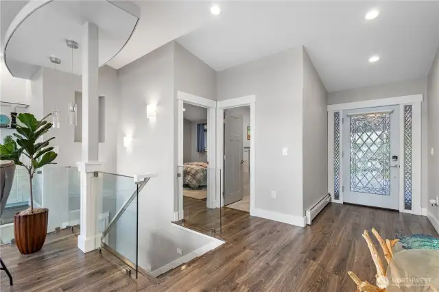 A guest bedroom/bath & glass rail stairway are just off the entryway.
