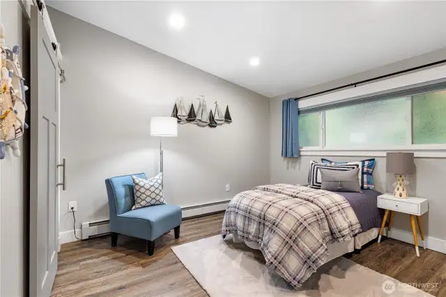 Main floor guest bedroom with vaulted ceiling & sliding barn door.