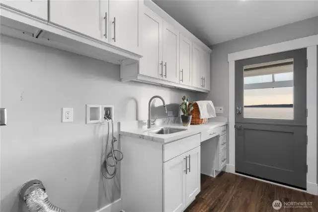 Laundry with custom cabinets & door to the patio. Even laundry day gets a view!
