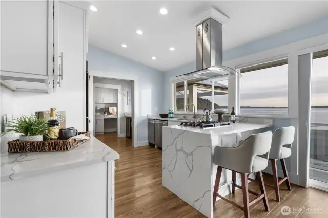Stainless appliances & quartz waterfall breakfast bar.