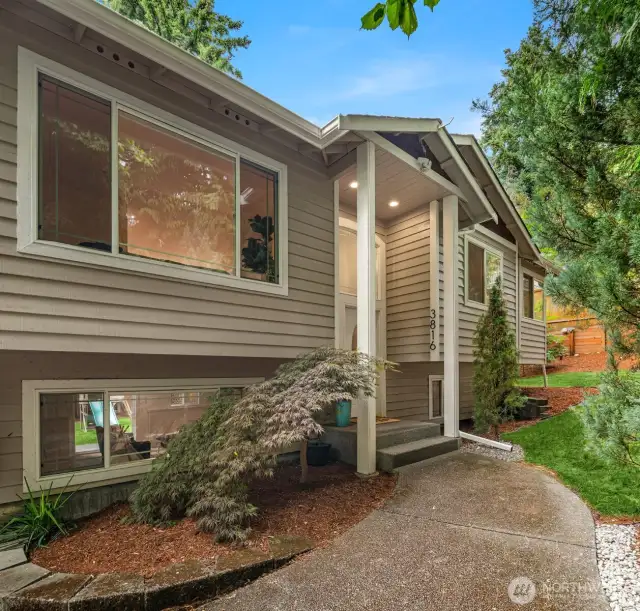 Tasteful landscaping surrounds the house.