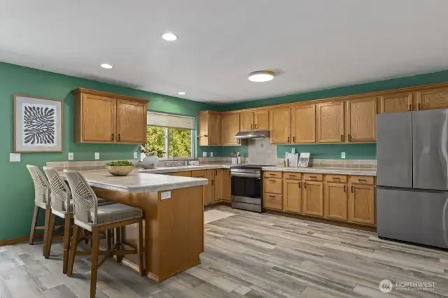 This kitchen is huge! In addition to the cabinet and counter storage, there's an oversized walk-in pantry next to the door to the formal dining room. Solid wood cabinetry, a custom tile counter and backsplash, and all new appliances create a kitchen where daily chores become simple.