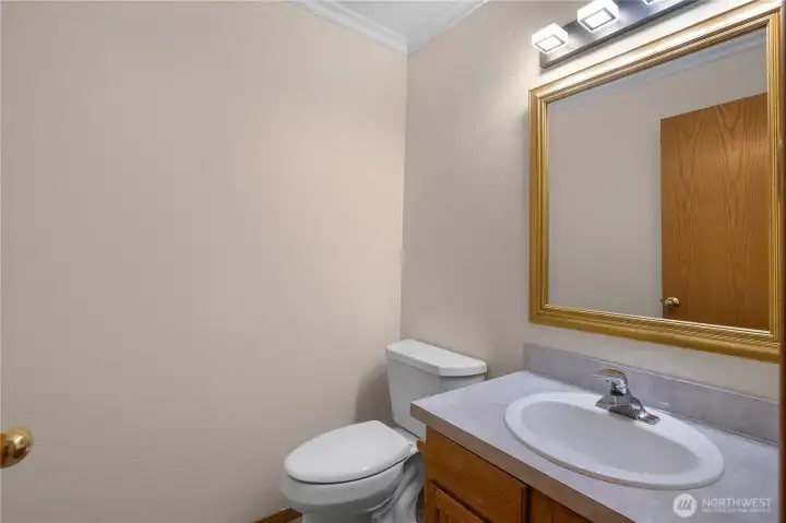 Tucked into the hallway, across from a large coat closet, the powder bathroom offers additional storage that makes it easy to keep supplies stocked.