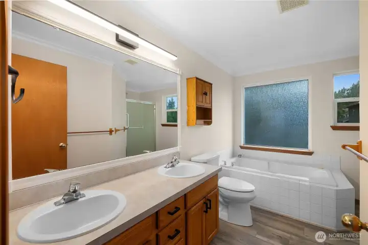 The primary bathroom includes dual vanities, a soaking tub and a separate shower.