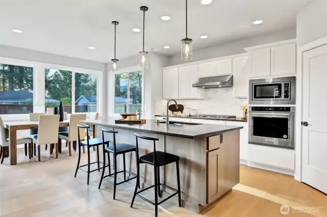 Kitchen and eating nook. Features stainless steel KitchenAid appliances. Pictures depict a previously built home similar to the home going to be built on this lot. Floor plans, Elevations, colors, upgrades & materials may be different.