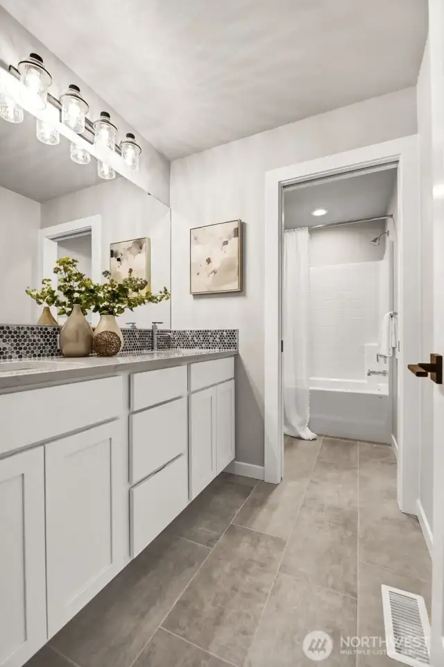 Main upstairs bathroom. Pictures depict a previously built home similar to the home going to be built on this lot. Floor plans, Elevations, colors, upgrades & materials may be different.