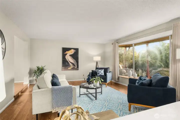 Front living room has hardwoods and sunny bench seat overlooking the front yard