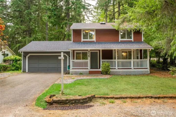 Grass area w/rock border and paved walkway to front porch