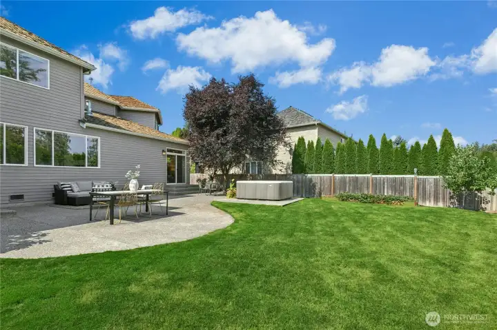 Expansive backyard with a manicured lawn, private garden, and serene outdoor retreat designed for relaxation.