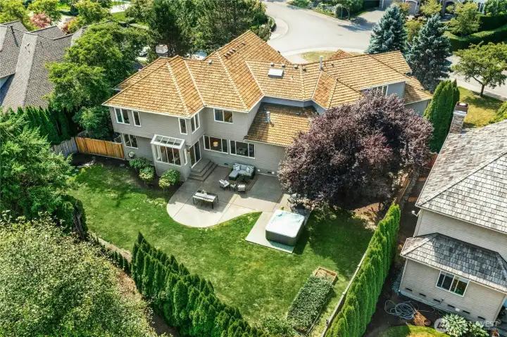Set on a half-acre+ lot backing to lush greenspace with Cascade Mountain views