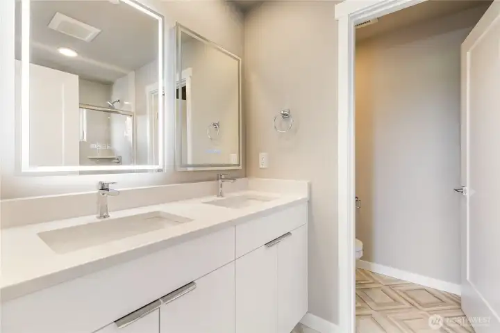 Primary ensuite with back lit mirror.  Pic for reference of like unit. 552 Northview is under construction.