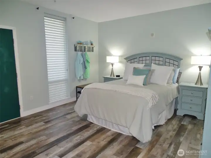 Entry into this Open Bedroom. Beautifully remodeled w/ vinyl-plank flooring through-out (w/ cork underlayment).  NOTE: They changed out the headboard.