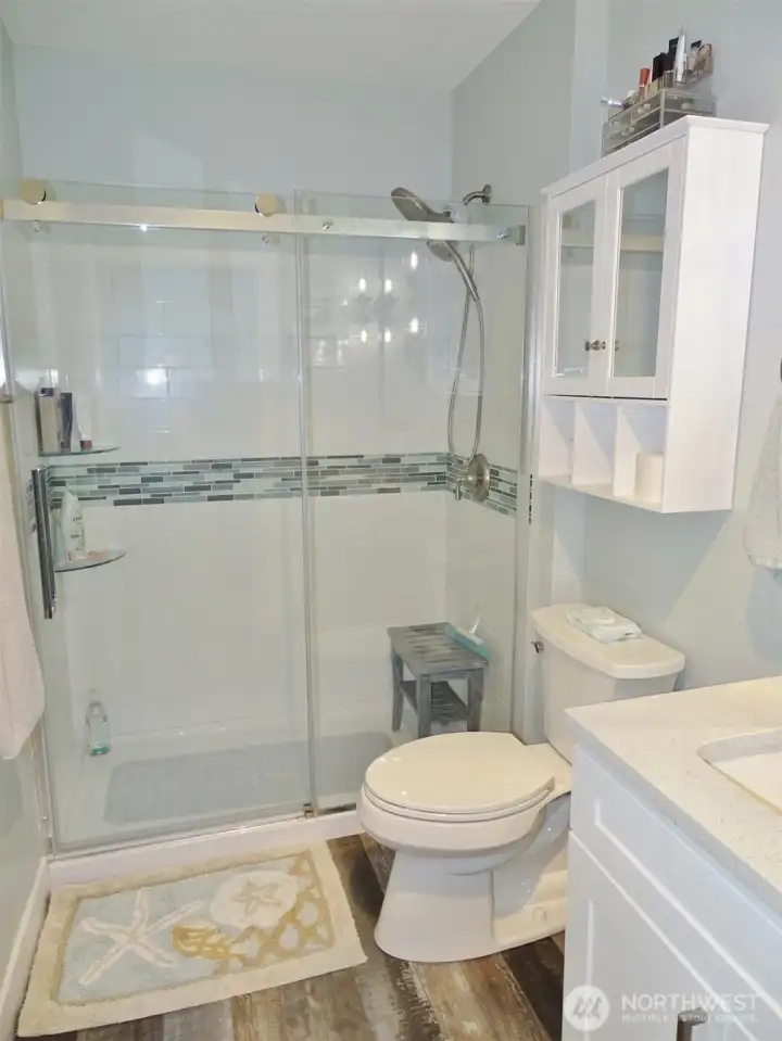 Beautiful walk-in shower with tiled walls.