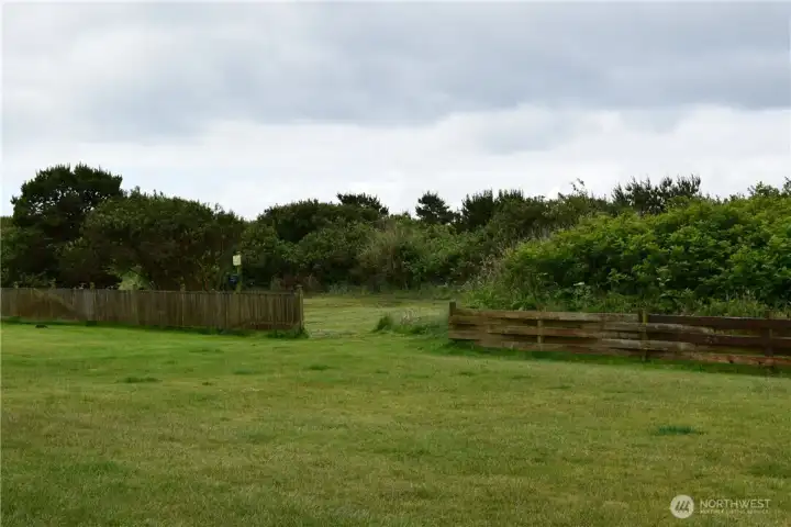 Lawn area.  Beyond fence is pet walking area.  The beach is just a bit further!