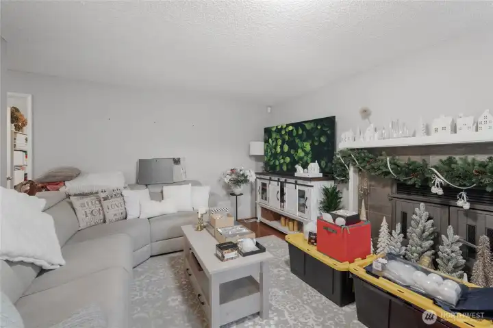 The Living Room also wraps around in the back with a hallway to the Primary Bedroom and bathroom all the way to the Kitchen.