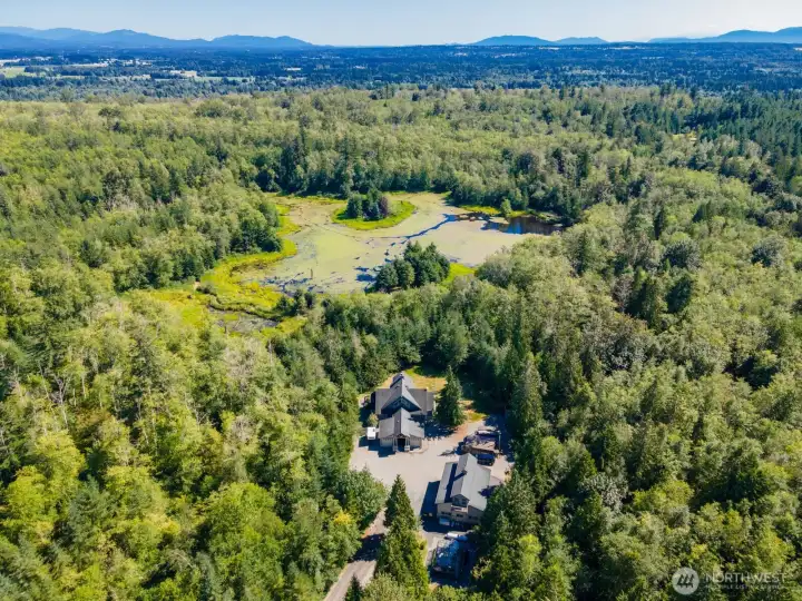 Looking down on to this beautiful estate of approximately 70 acres (4 separate parcel numbers) surrounded by evergreens, fruit trees a 8 ac lake and Haynie Creek.