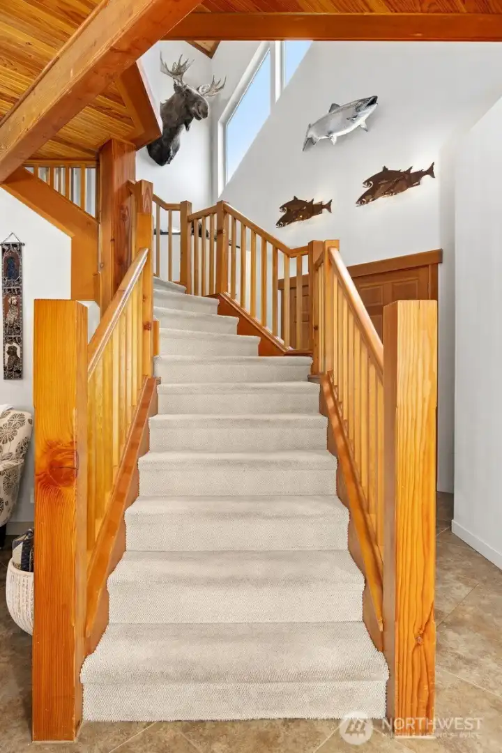 The solid wood stairway leading to the primary suite is a work of art.