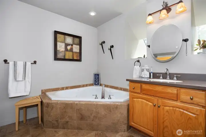 There is a corner soaking tub as well as a separate shower in the primary bath.