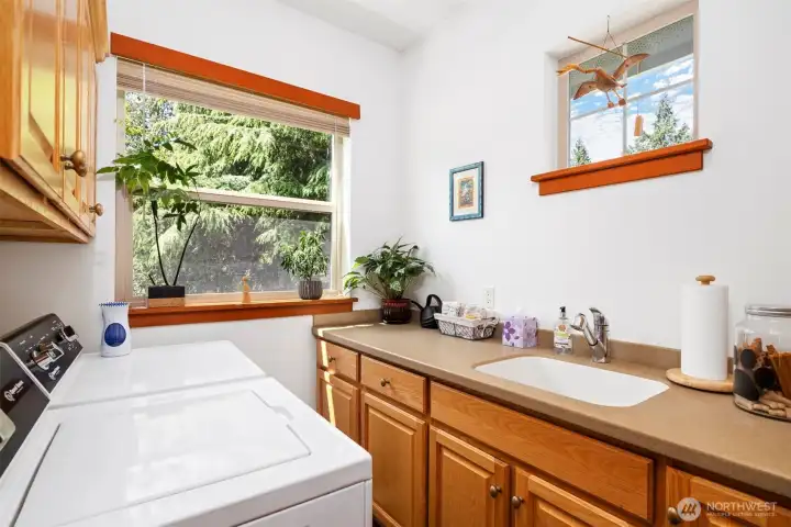 The laundry room is near the back door and has an abundance of cabinet storage and a nice, deep laundry sink.