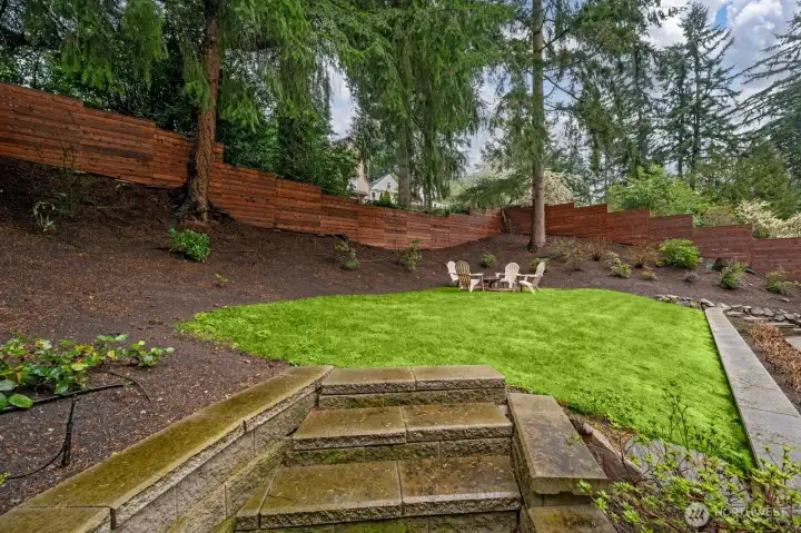 Upper level of backyard with fire pit area. Sellers had golf simulator